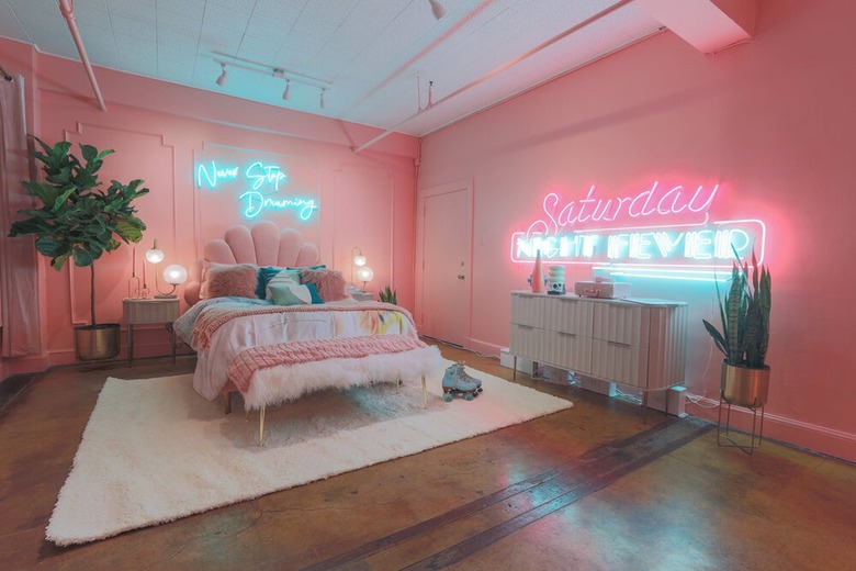pink bedroom with neon signage