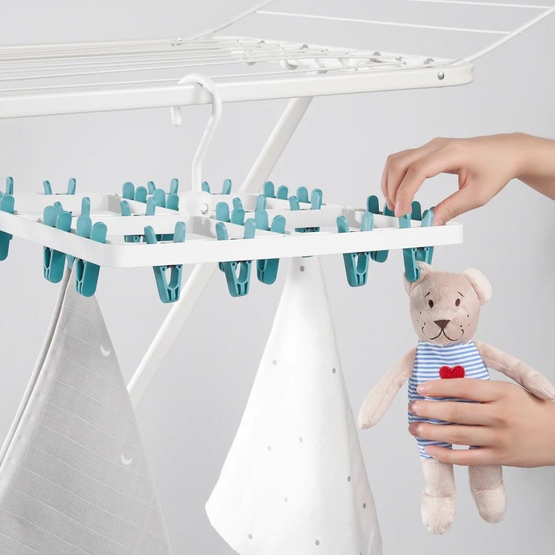 A clothes hanger with 24 blue clothespins