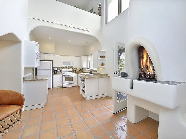 A white interior kitchen with arched ceilings and doorways