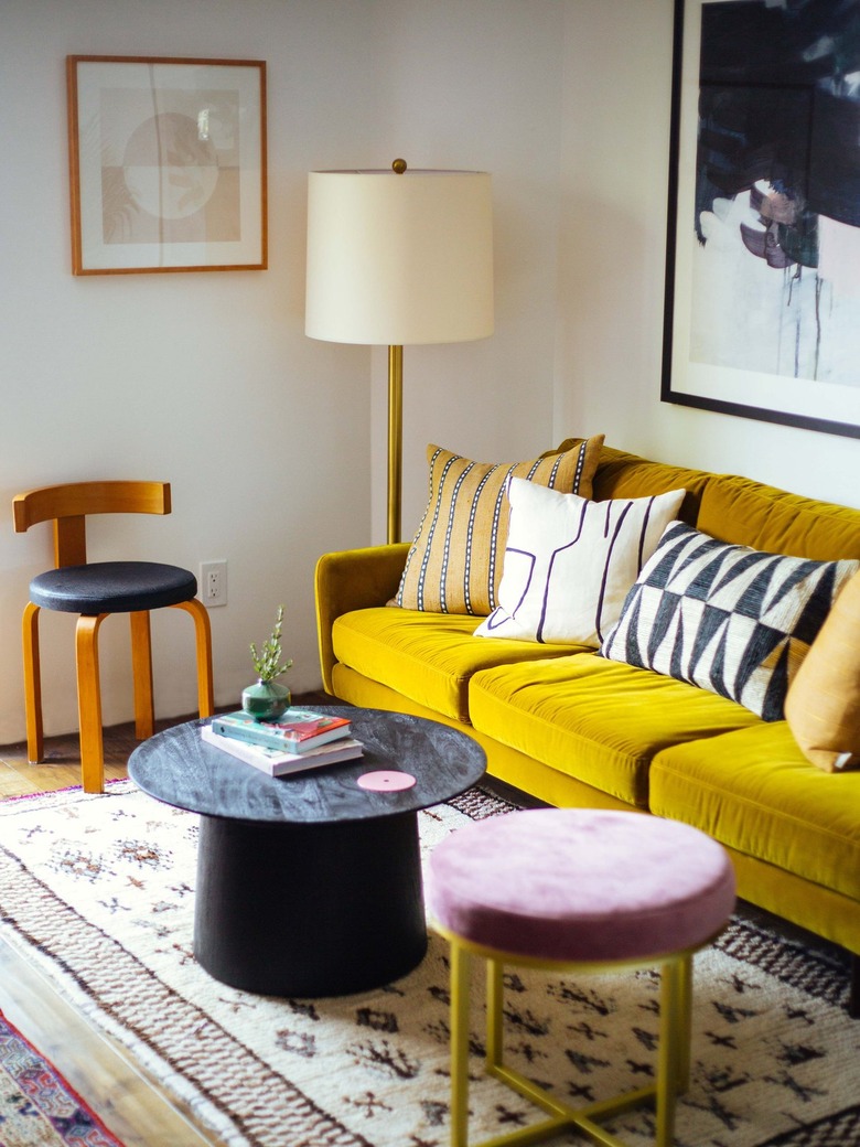 vintage and modern living room with yellow velvet sofa