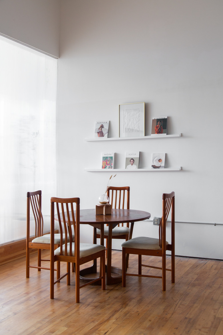 wood table and chairs with white shelves