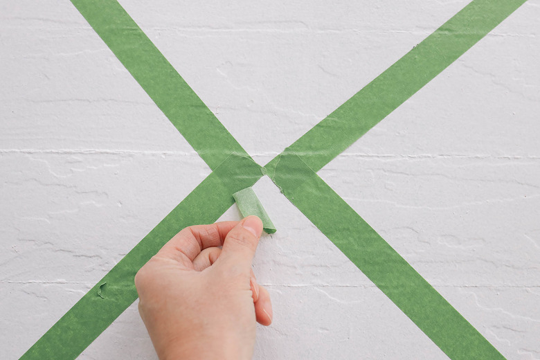 Green painter's paint on white floor