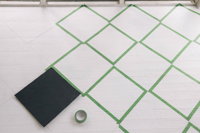 Taping diamond pattern on floor with painter's tape