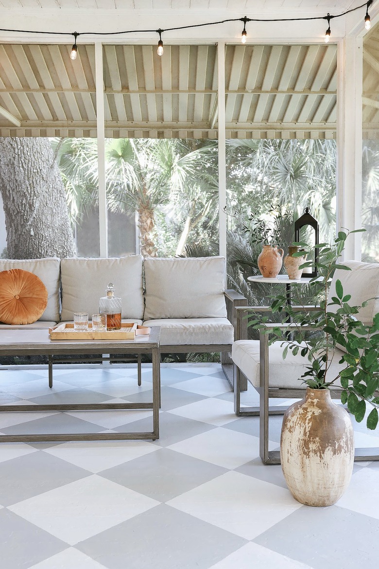 Painted gray and white checkerboard floor in sunroom