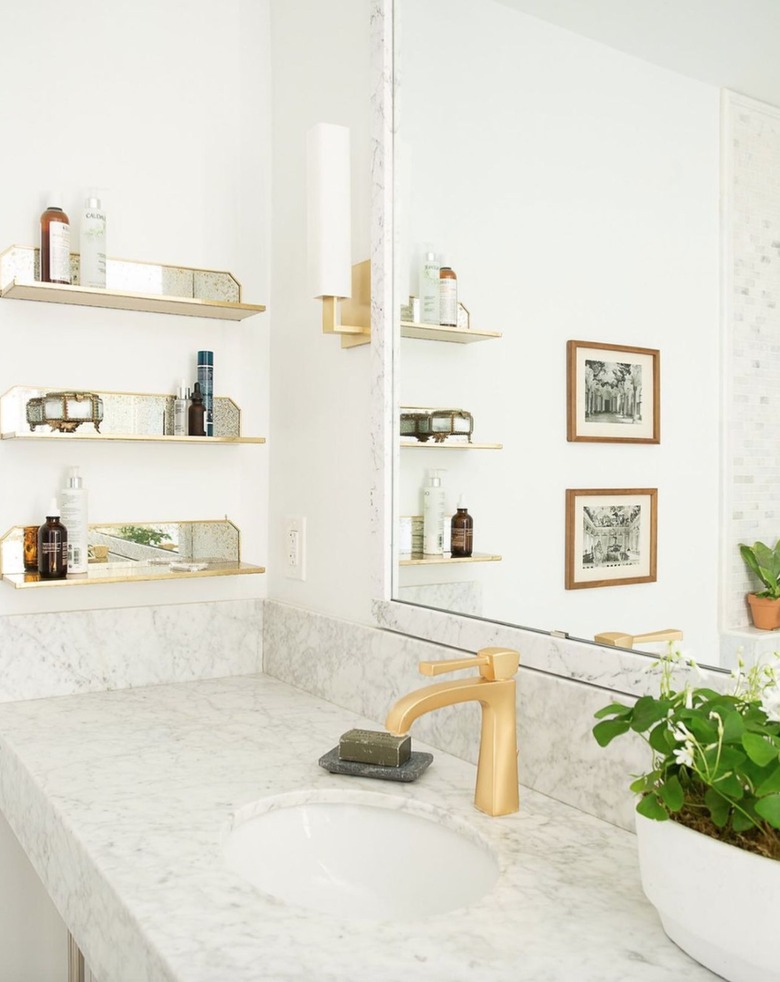 Bathroom sink area with open mirrored shelves
