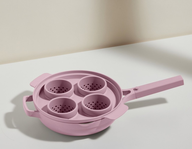 A lavender egg poacher with four compartments inside a lavender Always pan.