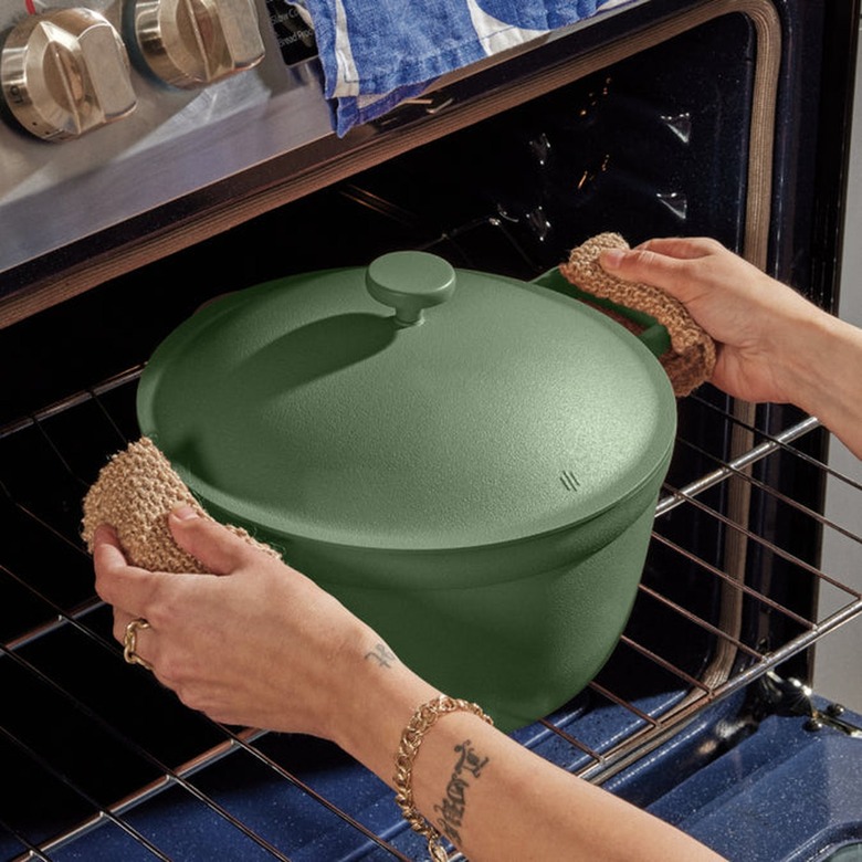 A green Perfect Pot is being placed in an oven.