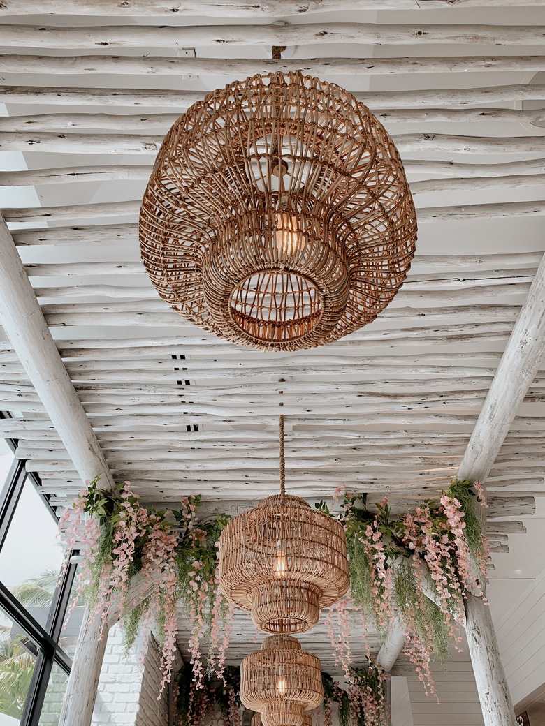 Vintage Boho Beach Style Rattan Lamps Hanging in a Tropical Indoor Setting in West Palm Beach