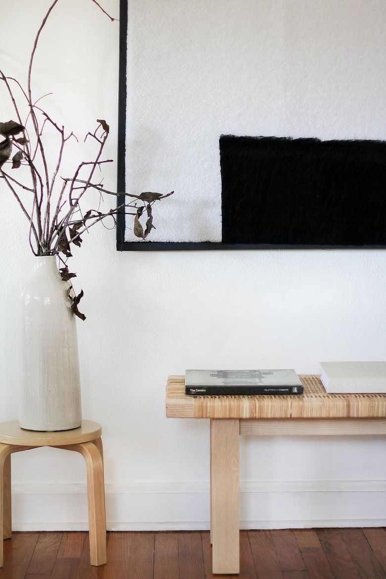 Minimalist black-white shearling wall art with bench