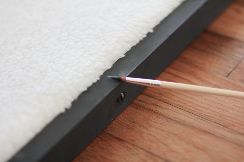 White shearling with black frame painted with paint brush