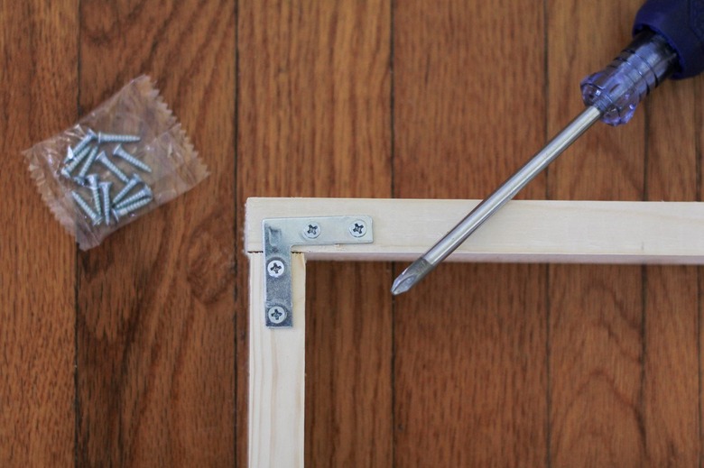 Wood frame with screwdriver and bag of screws