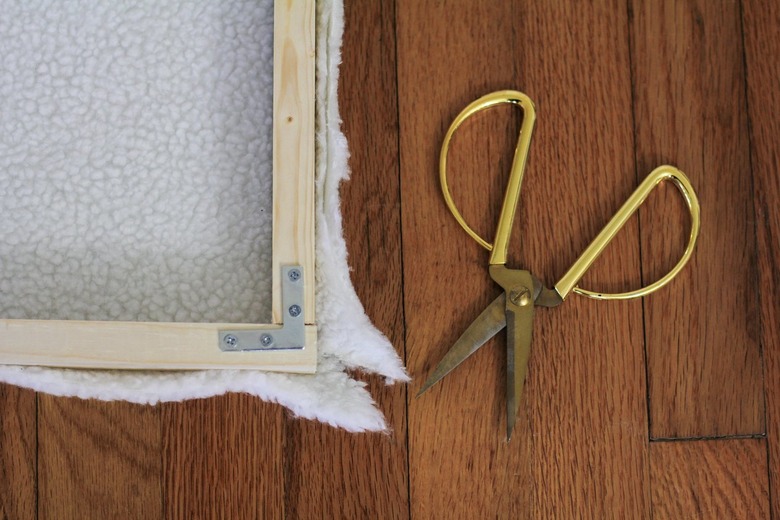 Wood frame with white shearling with gold scissors