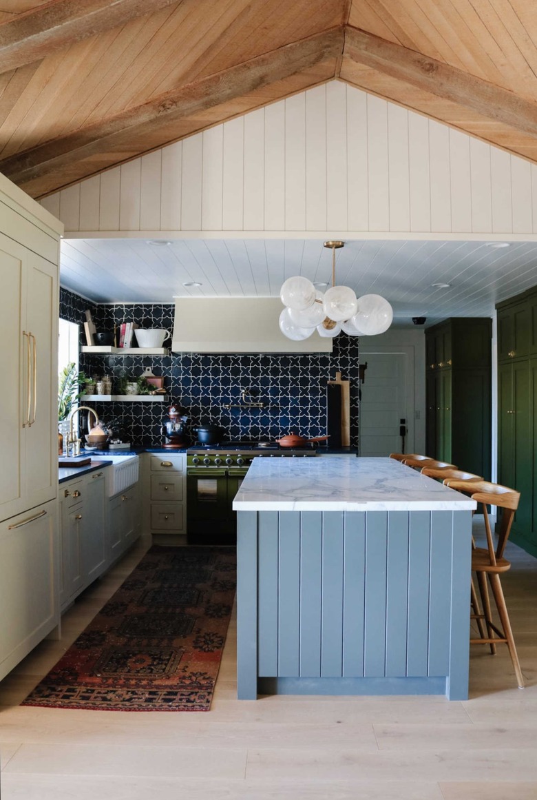 blue gray island with white cabinets