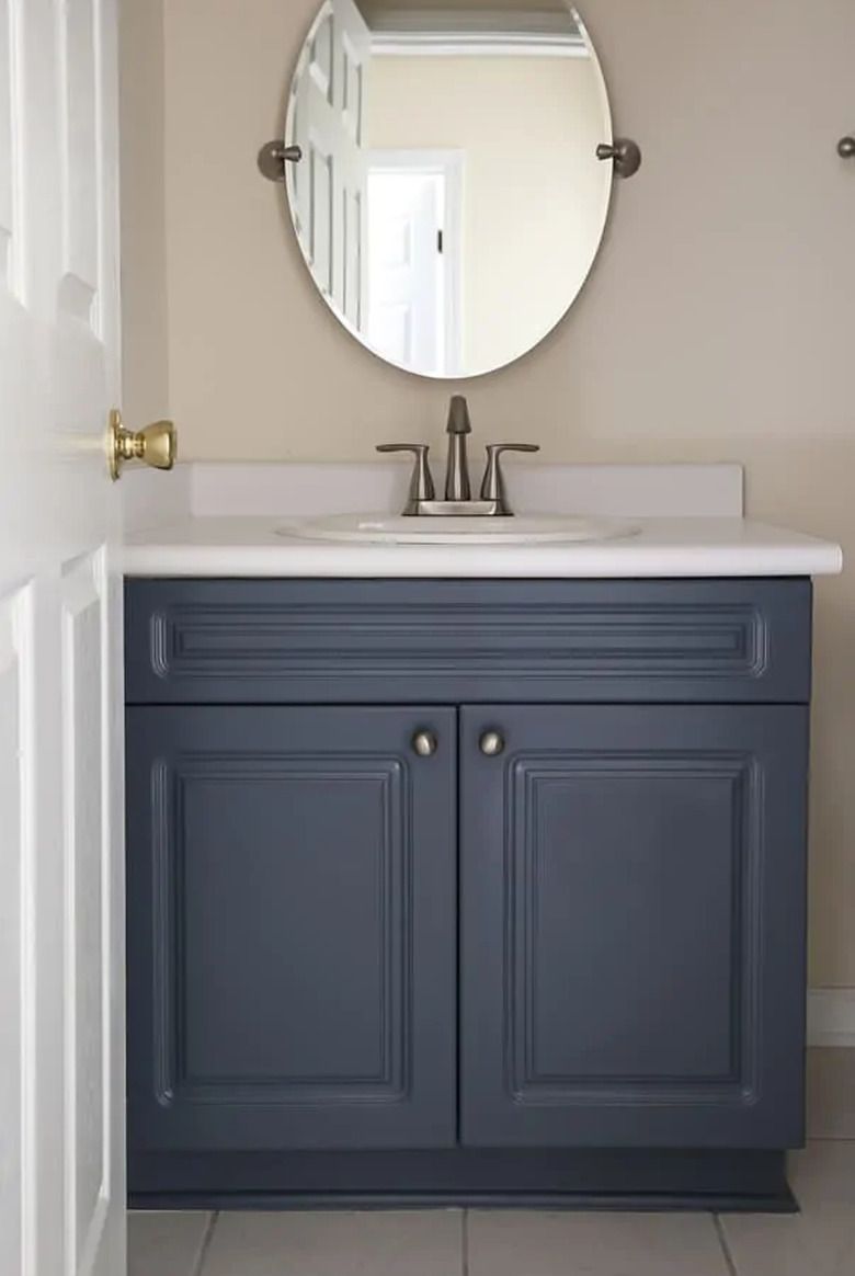 Painted bathroom cabinets before and after featuring blue vanity