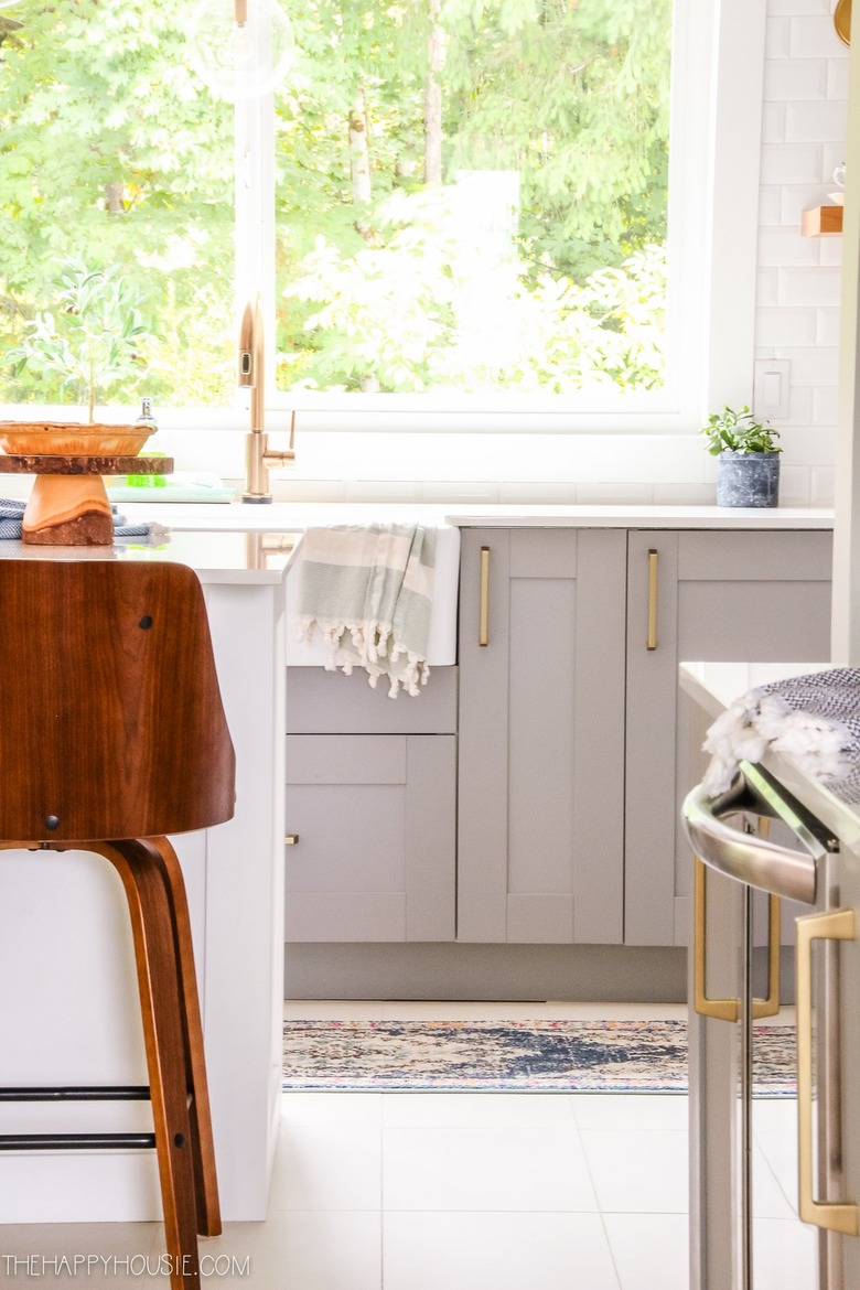 light gray kitchen cabinets with apron front sink