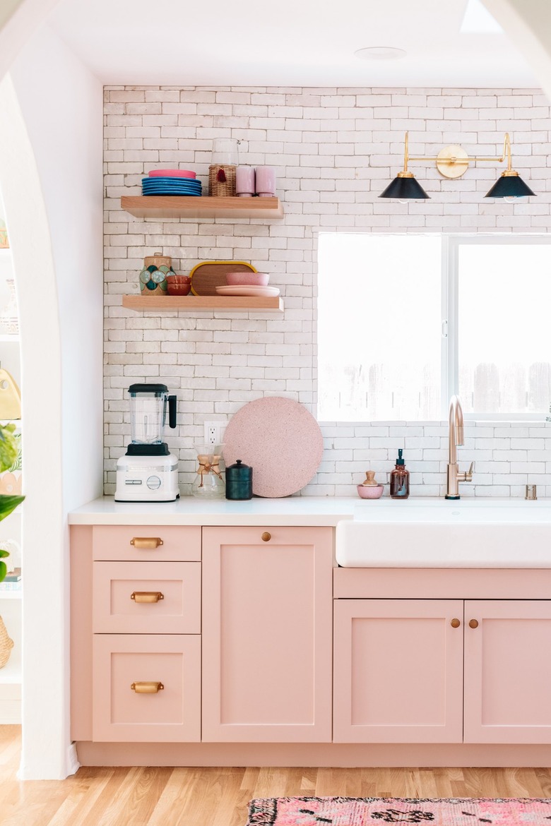 pink kitchen cabinets with white tile backsplash