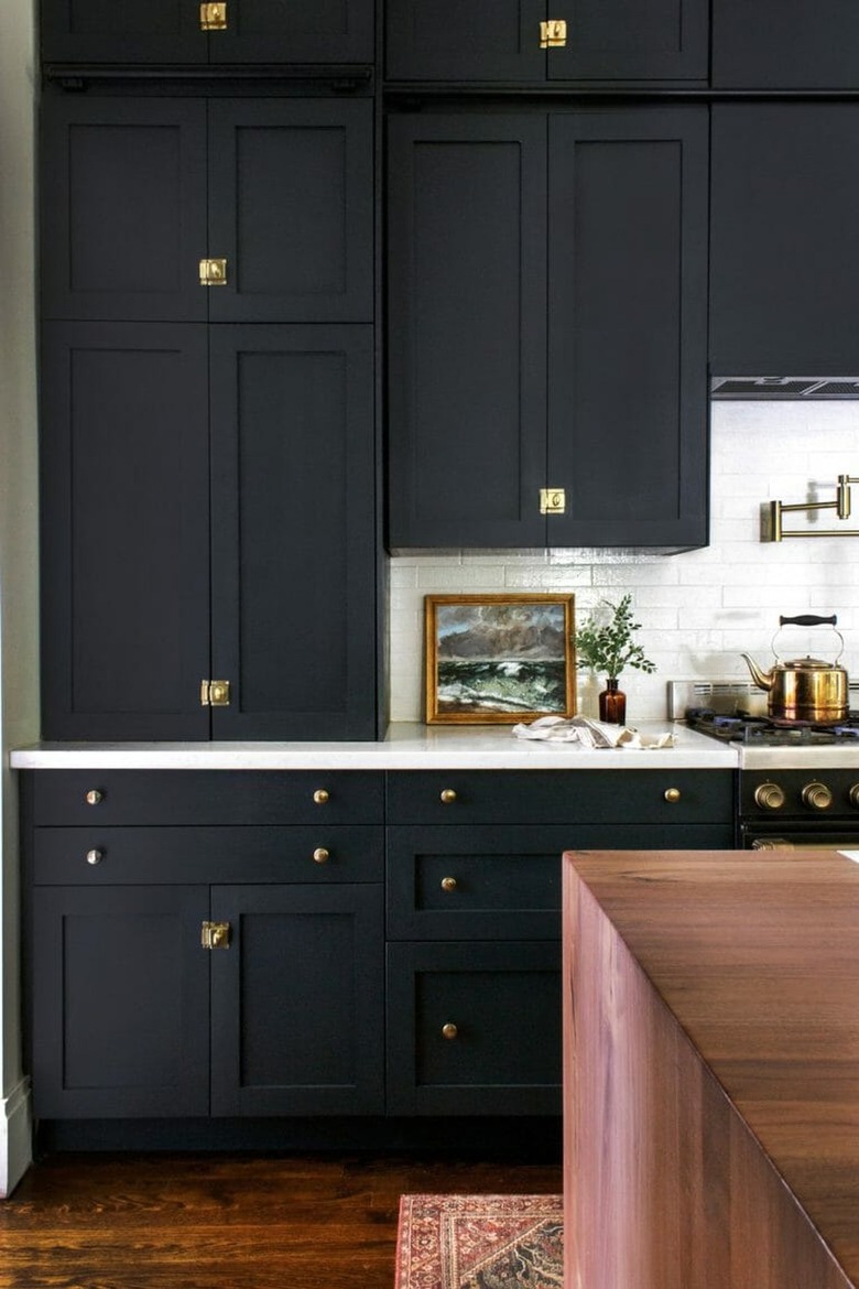 black kitchen cabinets with white subway tile backsplash