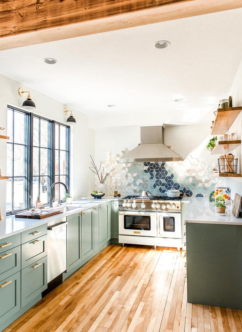 sage green kitchen cabinets with modern backsplash