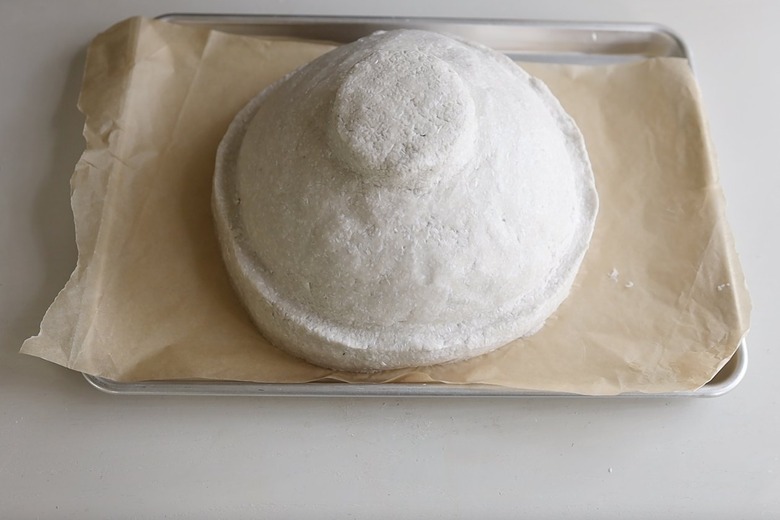 Paper mache bowl drying on parchment-lined baking tray