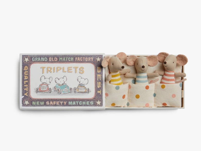 A matchbox that opens up to reveal three mini stuffed mice toys in blue