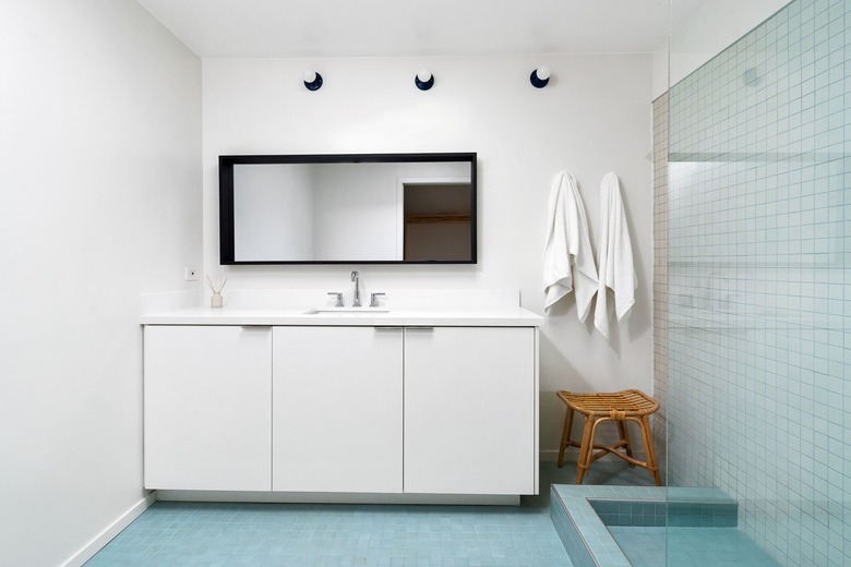 bathroom with white cabinets