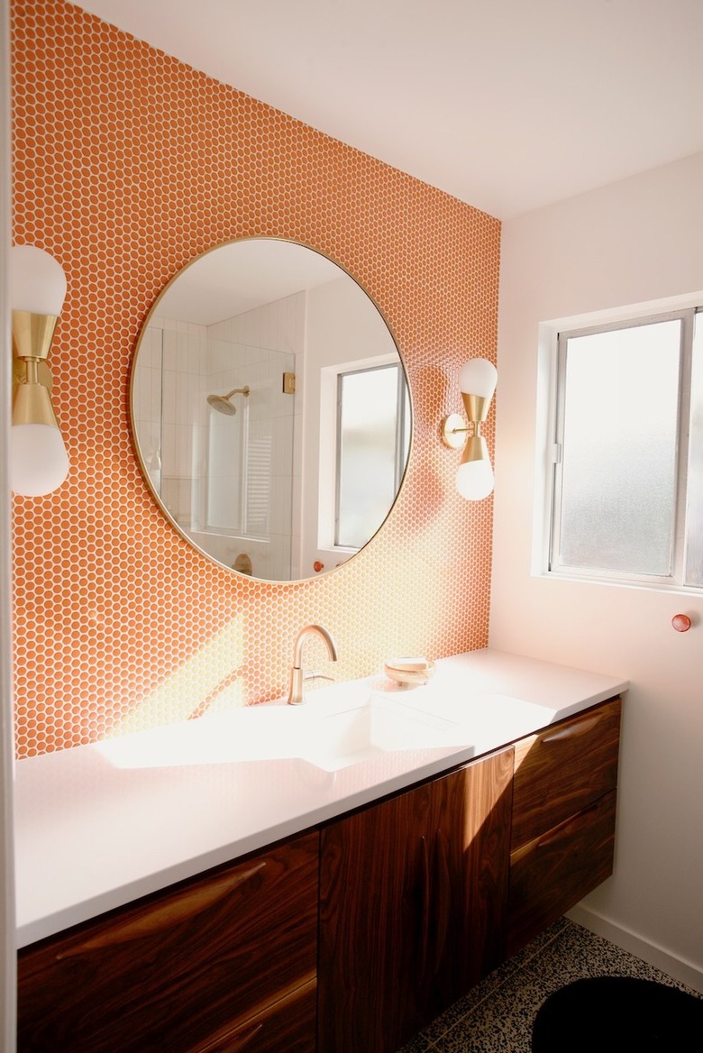 midcentury modern bathroom with orange penny tile backsplash