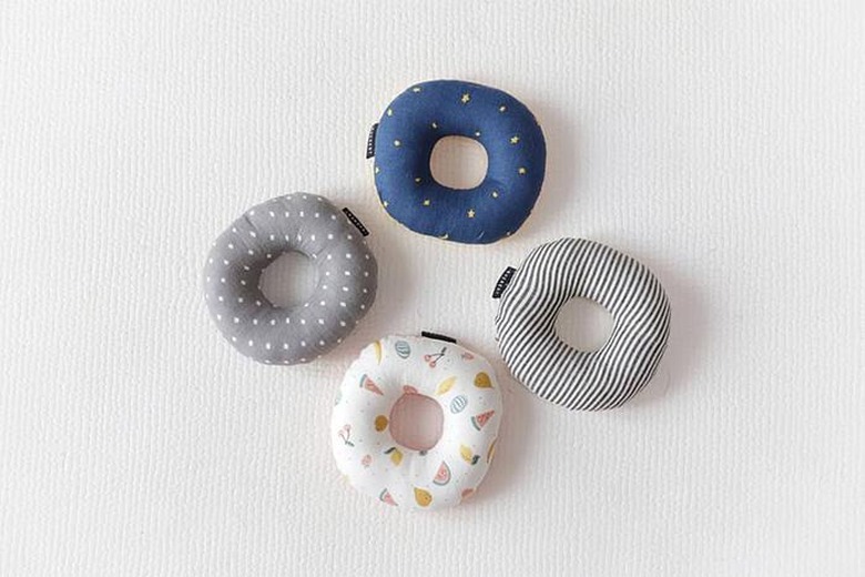 four round cat toys in various colors