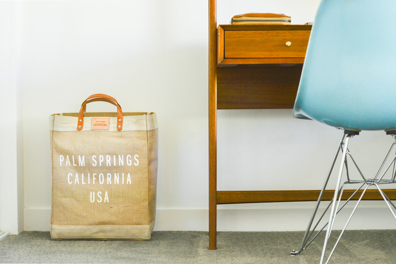 Desk with blue chair and brown bag on floor
