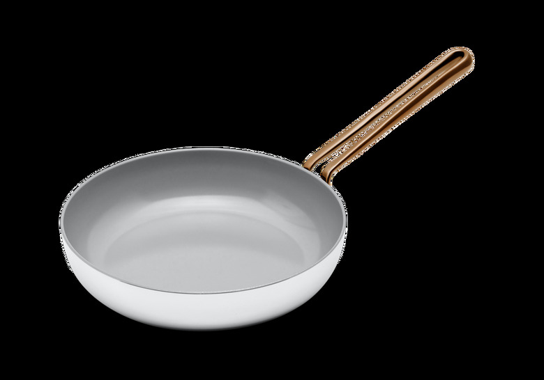 White ceramic nonstick cookware pan with rounded brass handle