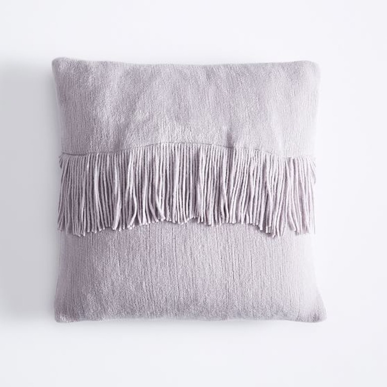 purple throw pillow with fringe detail