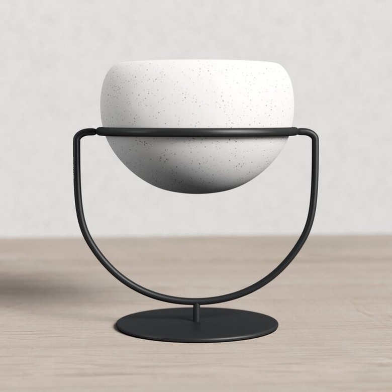 white planter in black stand