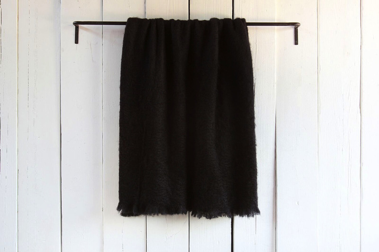 Black mohair throw hanging on wall
