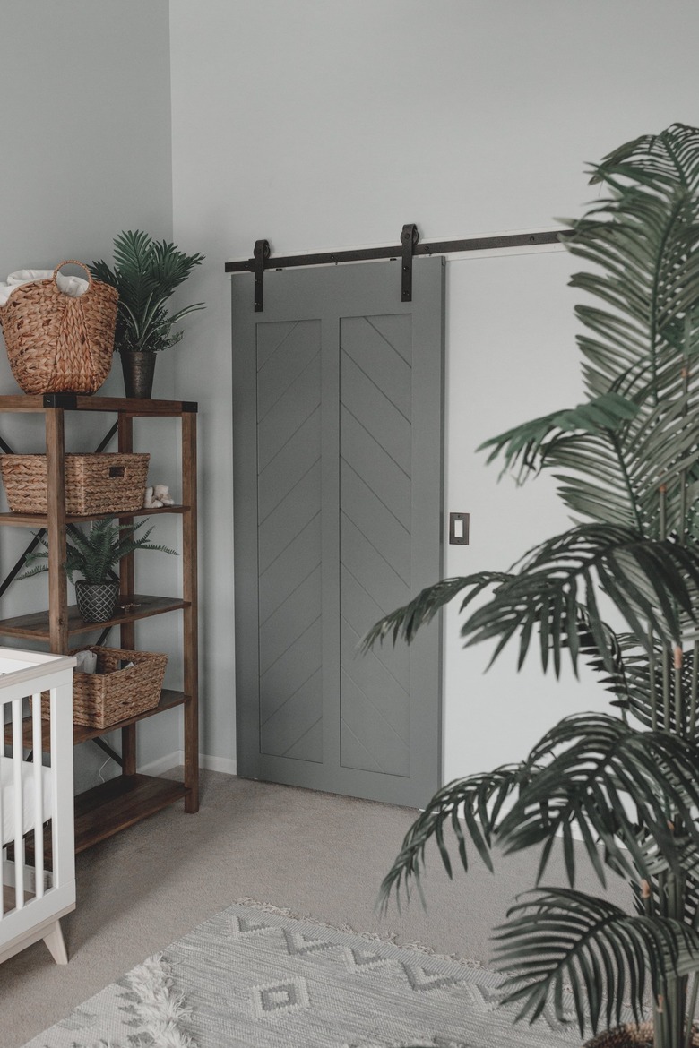 Behr paint color Light Drizzle in nursery with gray barn door