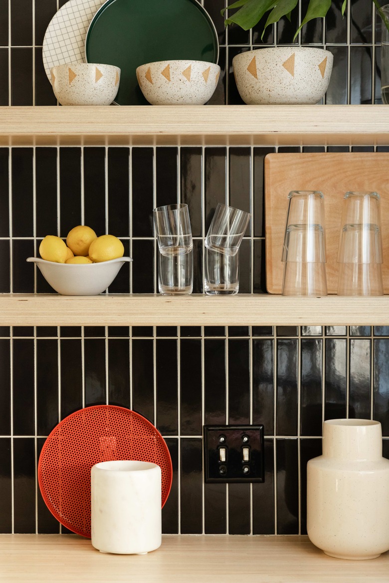 Close up of open shelving and tile work in kitchen