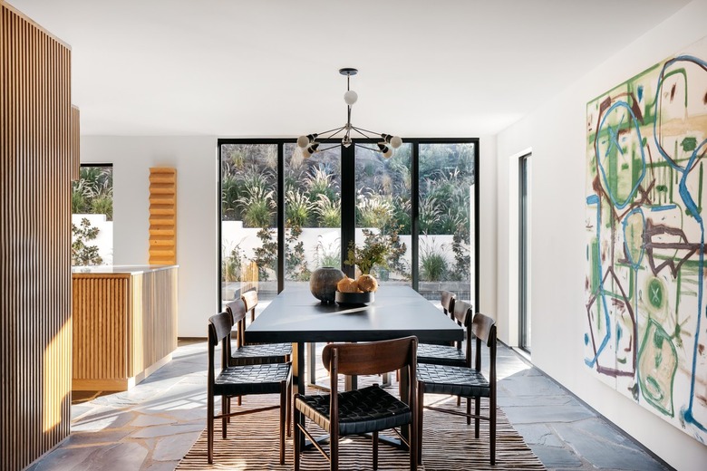 dining room with large glass door and painting