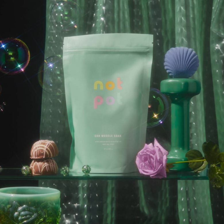 green bath soak package with bubbles and handweight