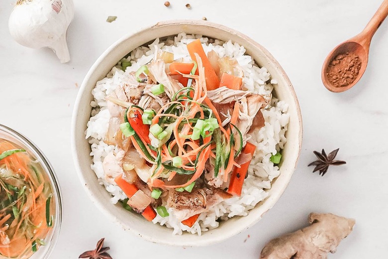 Postpartum chicken in a bowl with pickled vegetables on top