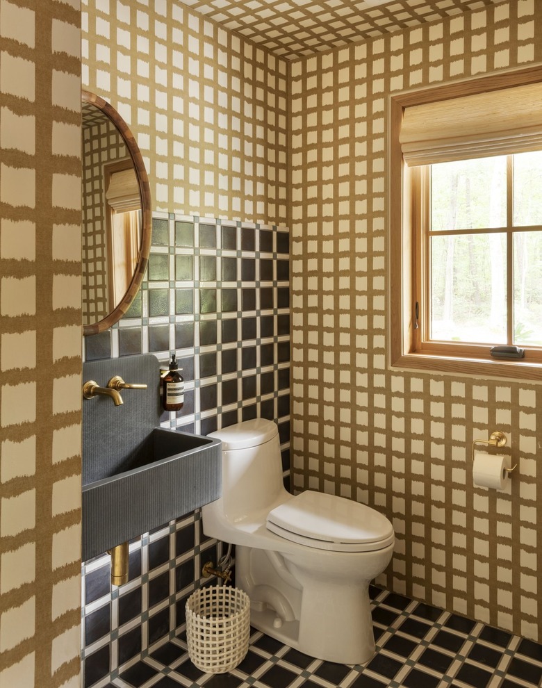 powder room with checkered wallpaper and tile plus a dark concrete sink