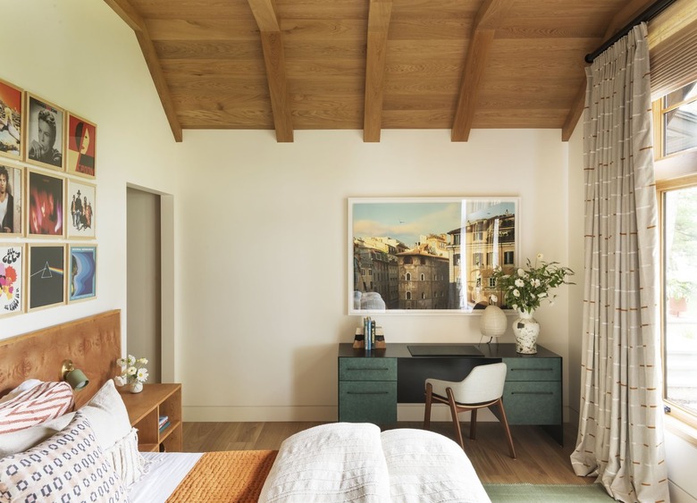 primary bedroom with wood plank ceiling and desk