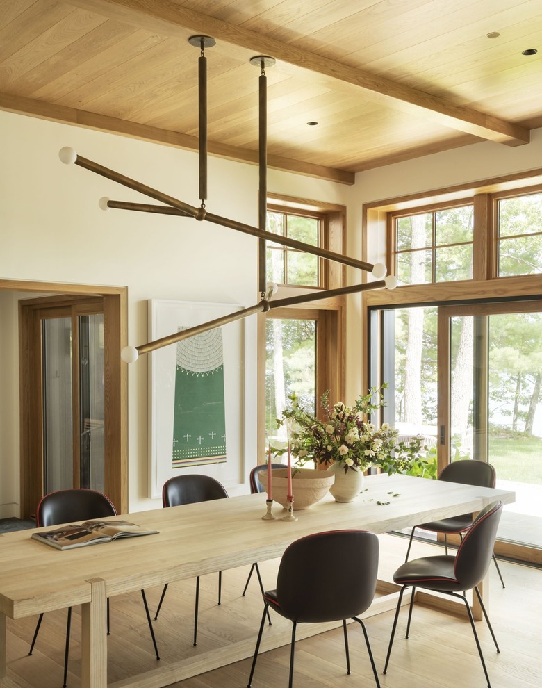dining area with a large chandelier and black chairs