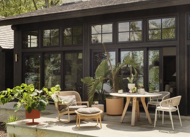 porch area with a round table and multiple chairs