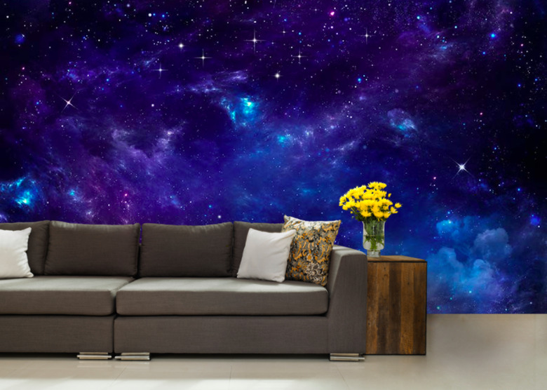 Couch with side table yellow flowers and space wallpaper