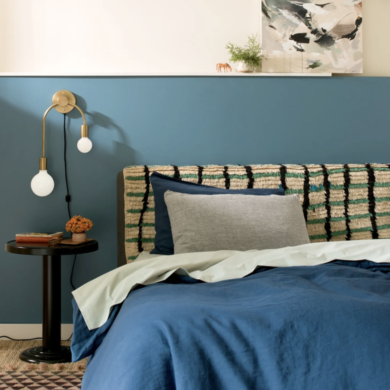 Brass double plug-in sconce by the bedside