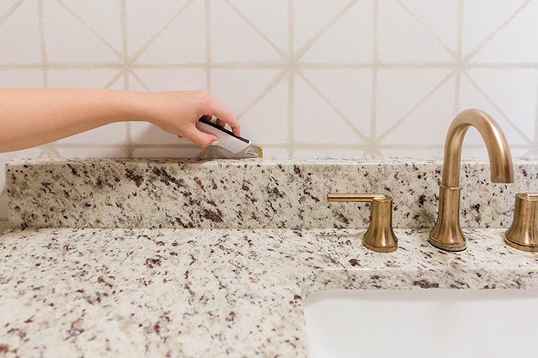 Run a utility knife along the edges of the peel-and-stick wallpaper.