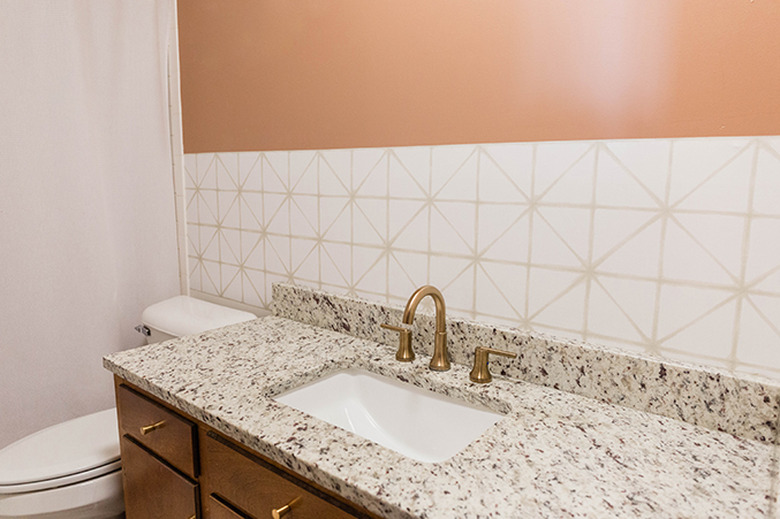 Remove everything from the wall that has the peel-and-stick wallpaper on it.