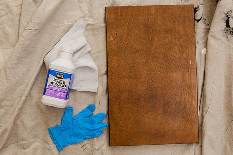 Use liquid sander deglosser to dull the finish on the doors and vanity surround.