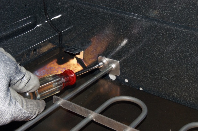 Removing oven heating element.