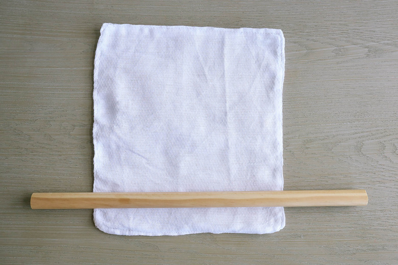Rolling fabric unpaper towel around dowel