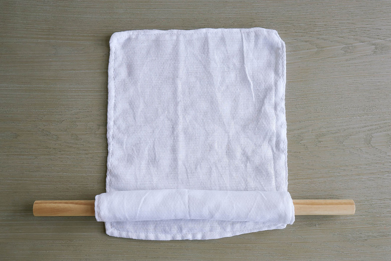 Rolling fabric unpaper towels around dowel
