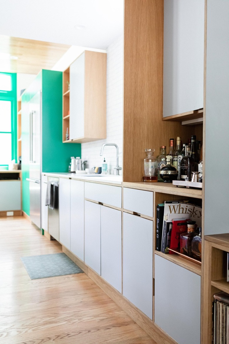 modern white kitchen with small rug in front of sink